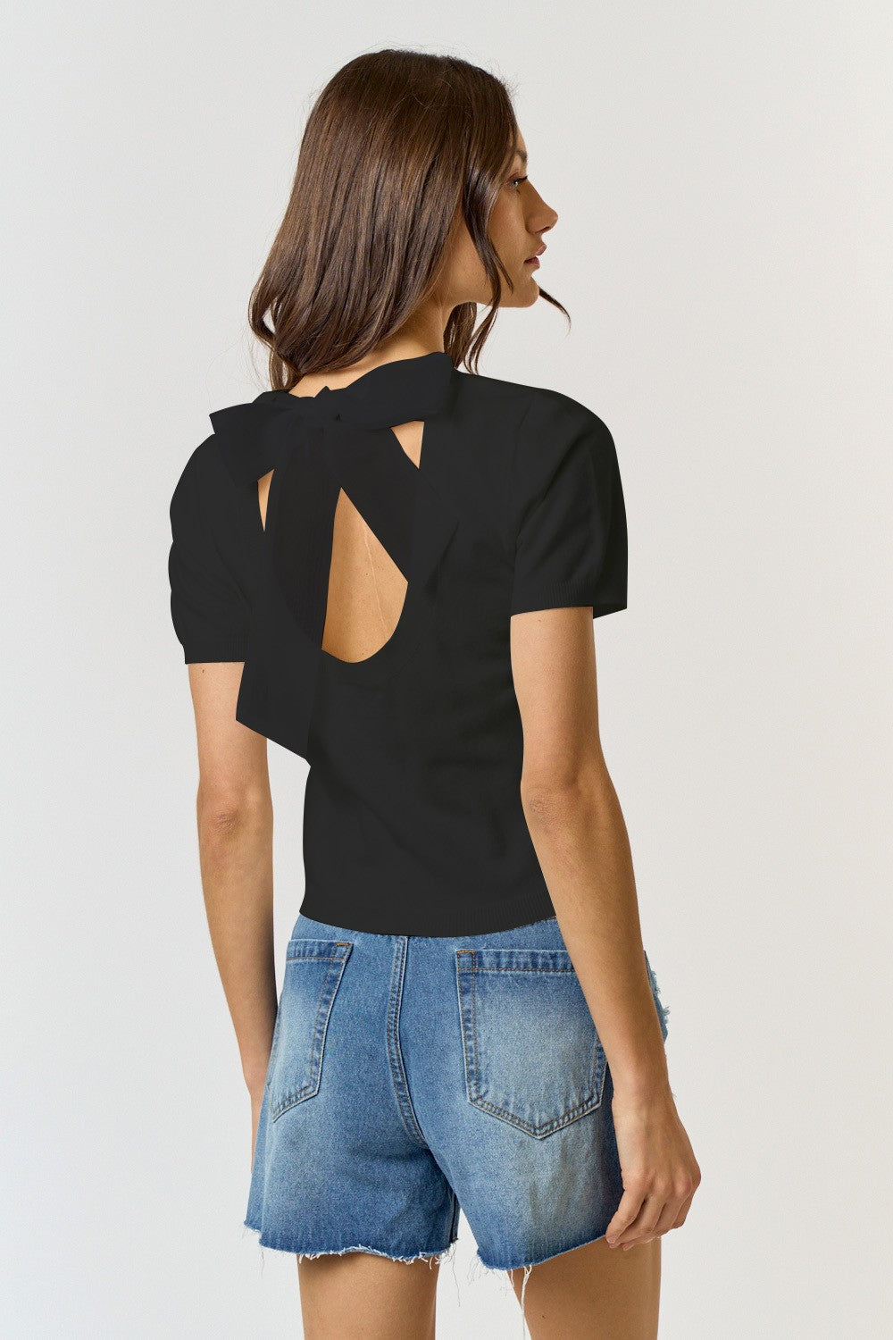 Back of Lalavon Bow Top modeled on a woman with jean shorts